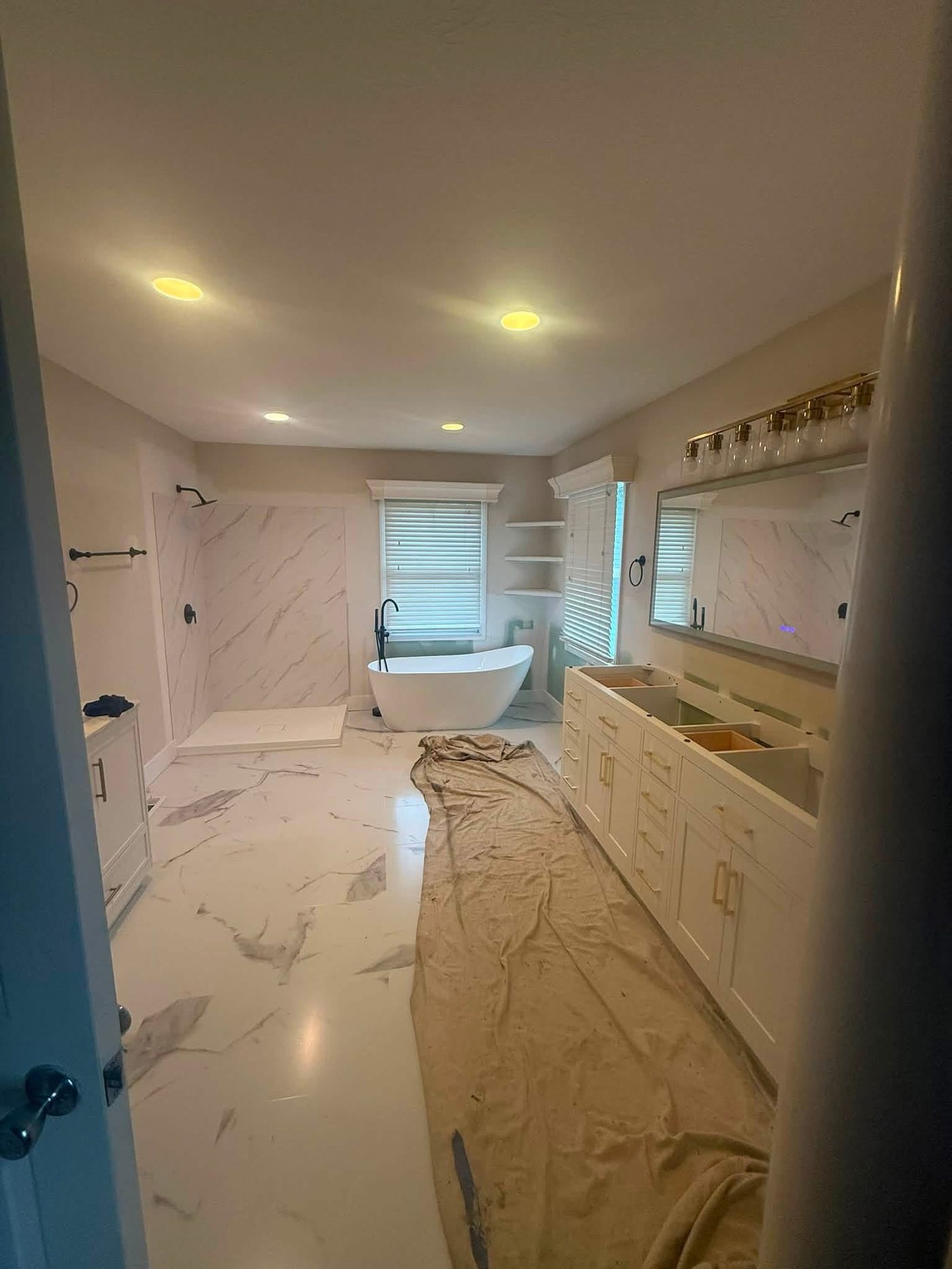 Same primary bathroom before repainting, with lighter neutral walls