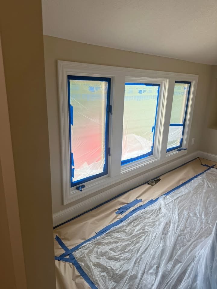 Windows carefully masked with painter's tape and plastic sheeting during preparation
