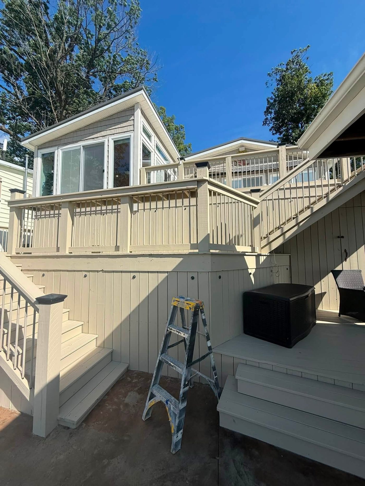 Painted deck, railings, and stairs on a multi-level home exterior