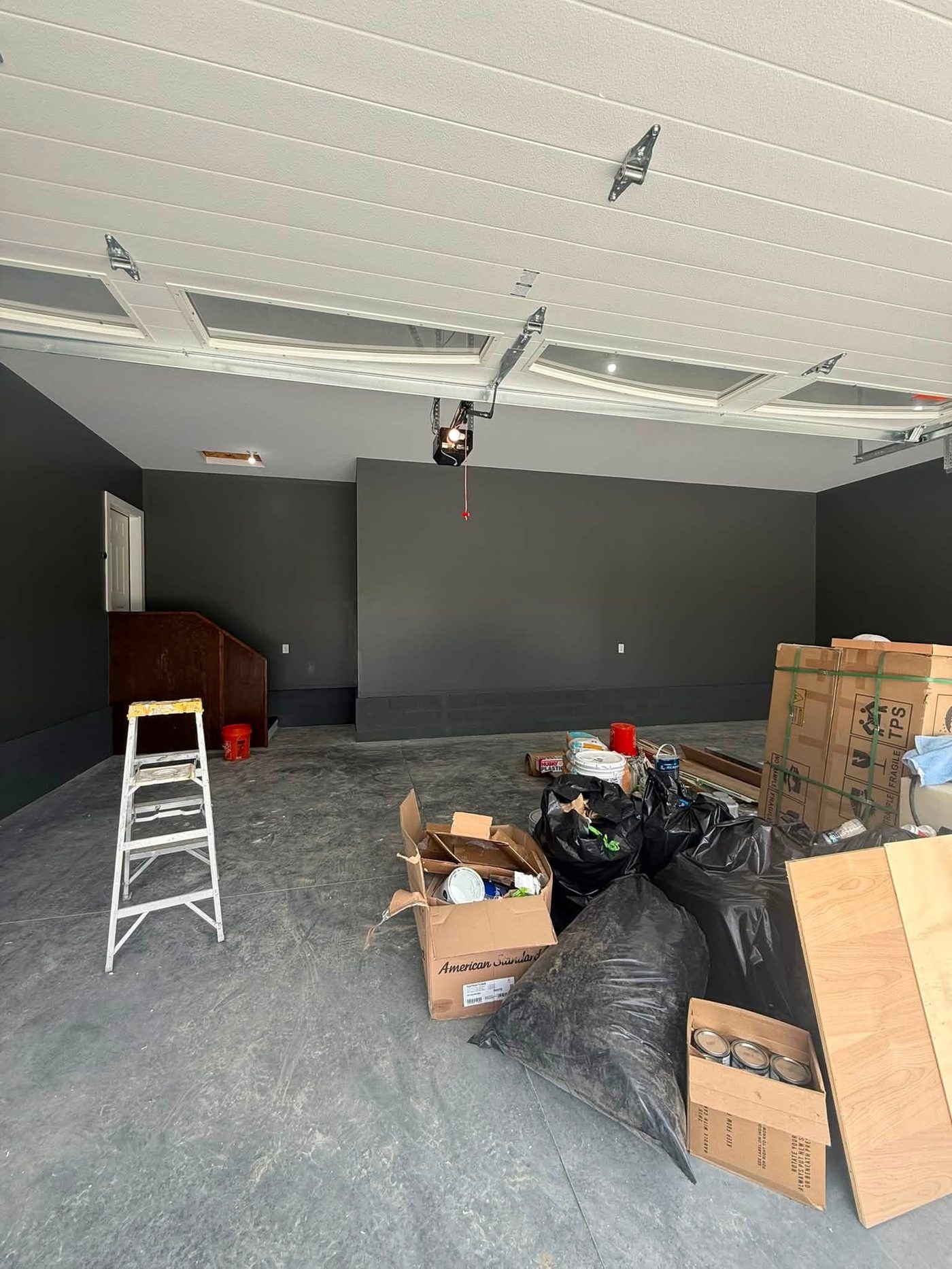 Garage interior mid-project with freshly painted walls and ceiling